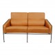 Arne Jacobsen 2-seater Airport sofa with cognac aniline leather and brass frame.